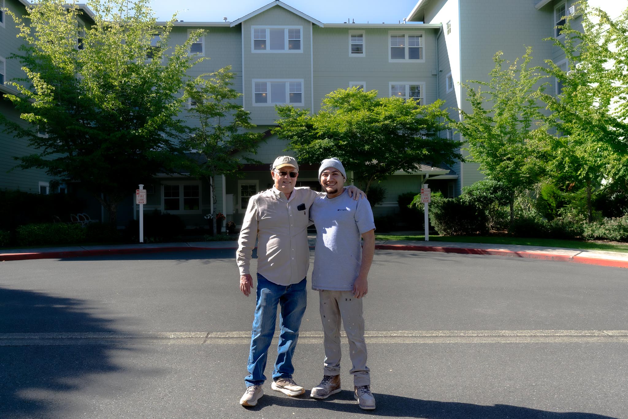 Shanco crew members outside a multifamily building in Seattle, ready for exterior painting work.