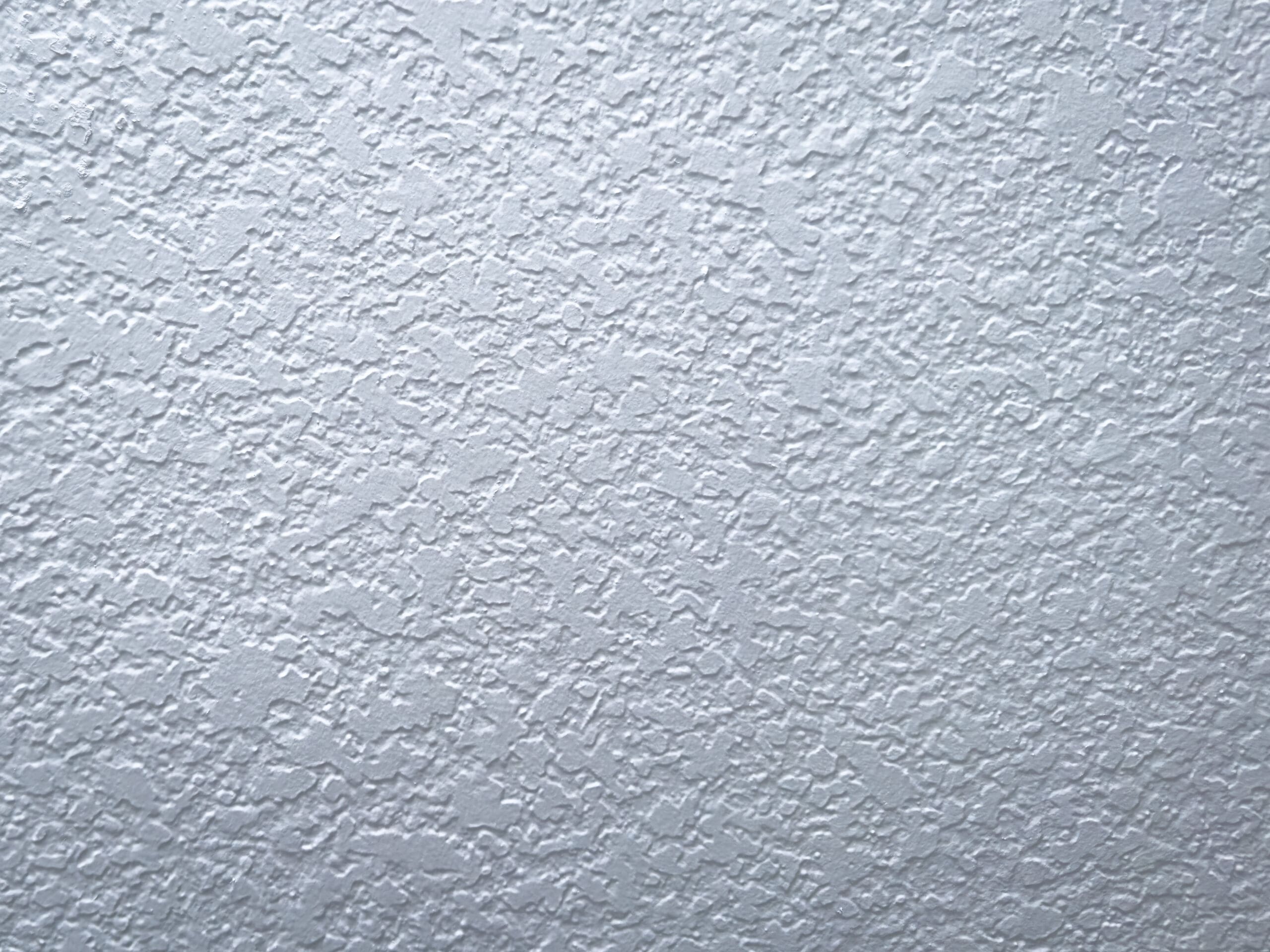 Light knockdown drywall texture close-up on freshly painted interior wall
